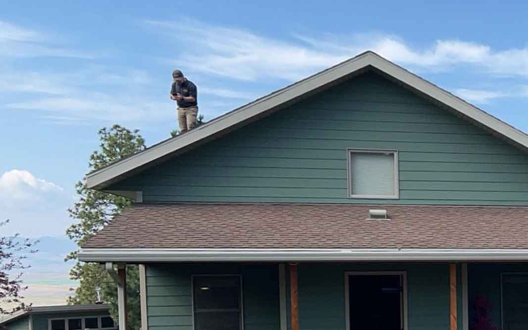 Comprehensive roof inspections include from the ground, from the ladder, from the roof, and from the attic inspections. Our inspector is taking detailed photos of the condition of the roof.