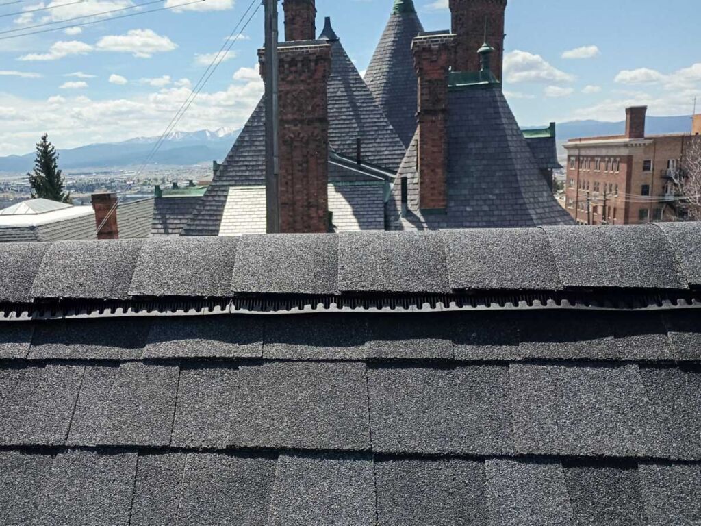 Balancing attic ventilation is one key element to extending the life of your roof. Mountain Roofing specifically stocks high profile ridge vent, like the one seen along the ridge on this Owens Corning Duration Onyx Black roof.